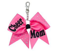 Hot Pink cheer mom bow keychain with sparkling rhinestone accents, black glitter “Cheer Mom” lettering, and a silver clasp attachment—perfect for bags, keys, or gifts.