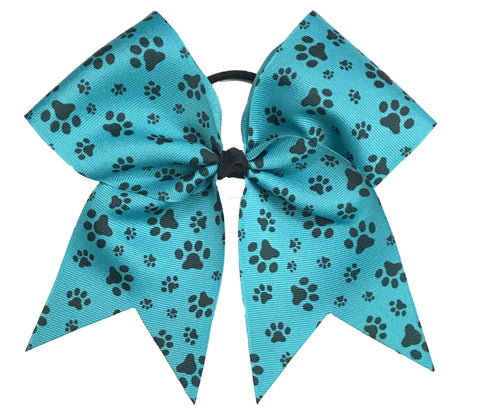 Teal jade hair bow with black paw prints on a white background