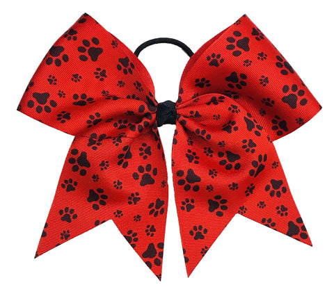 Red bow with black paw prints on a white background
