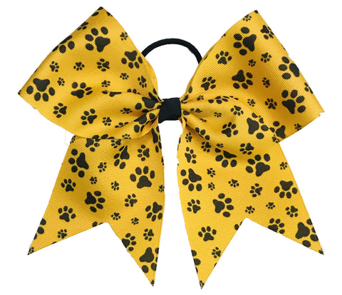 Yellow gold bow with black paw prints on a white background
