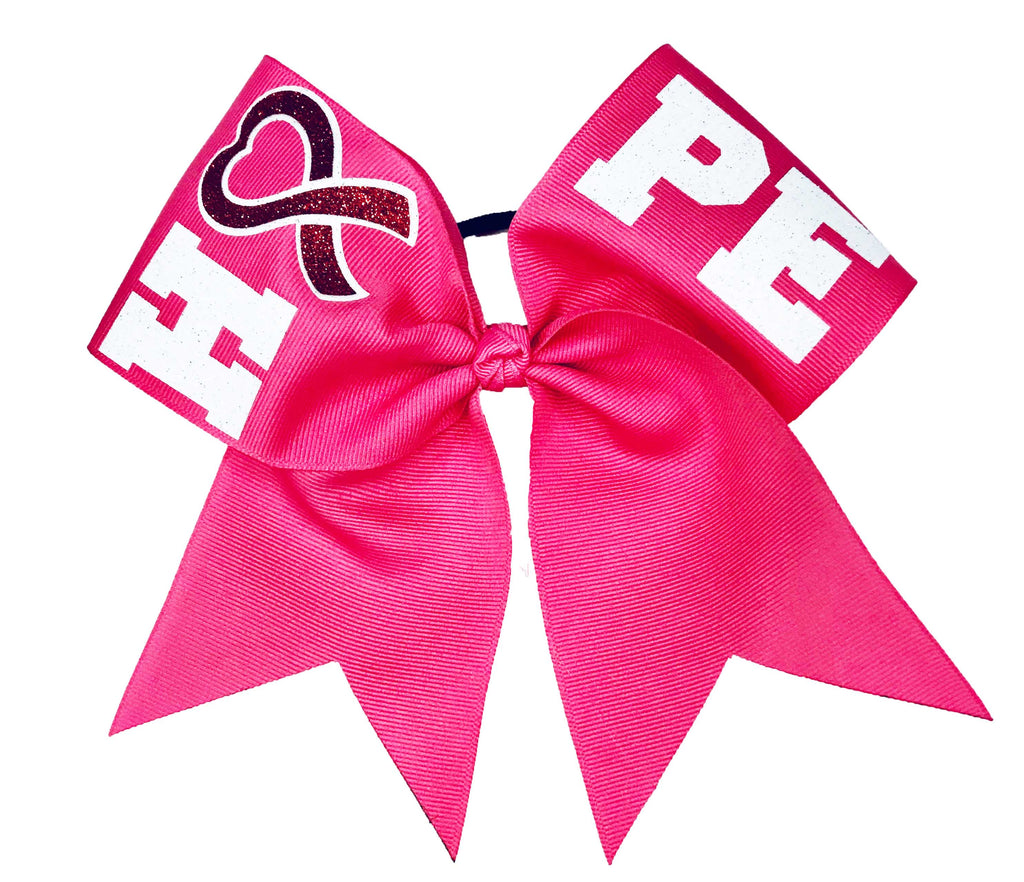 Pink breast cancer awareness cheer bow with 'HEART' and 'PEACE' text on a white background