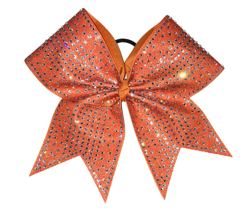 Orange glittery bow with  crystal clear rhinestones on a white background