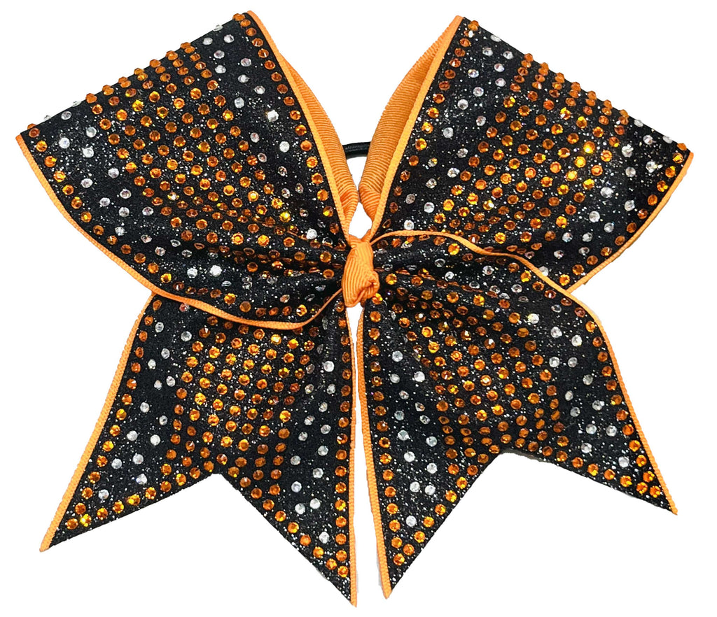 orange and clear rhinestones on a black glittery bow with a white background