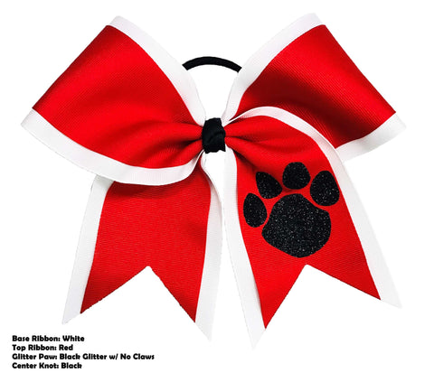 Red and white cheer bow with a black paw print design on a white background