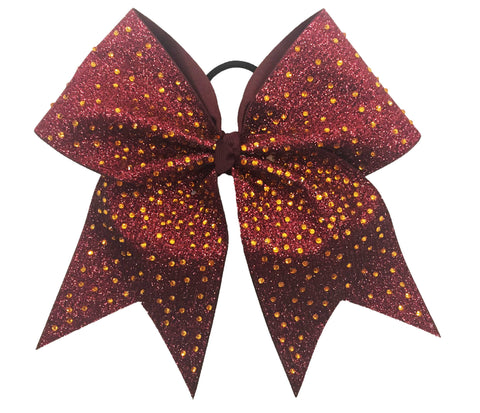 Maroon and gold glittery hair bow on a white background