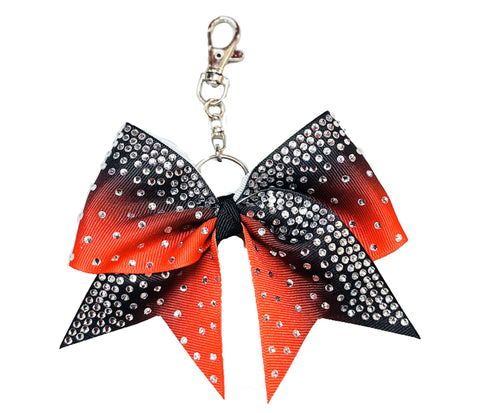 Black to red ombre Bow-shaped keychain with rhinestones on a white background