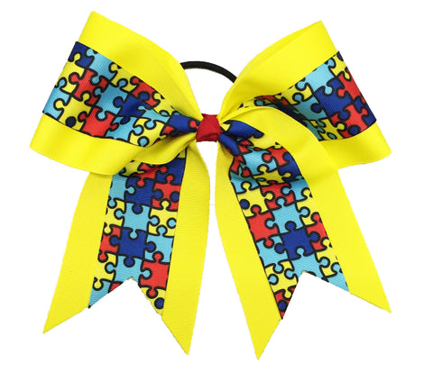 Yellow autism awareness cheer bow with puzzle pattern on a white background