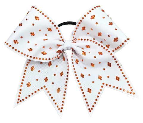 White bow with orange rhinestones on a white background