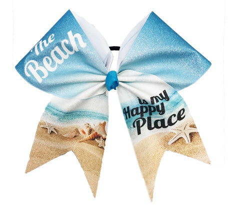 Hair bow with beach-themed design featuring sand, shells, and text saying "The Beach is my Happy Place" on a white background