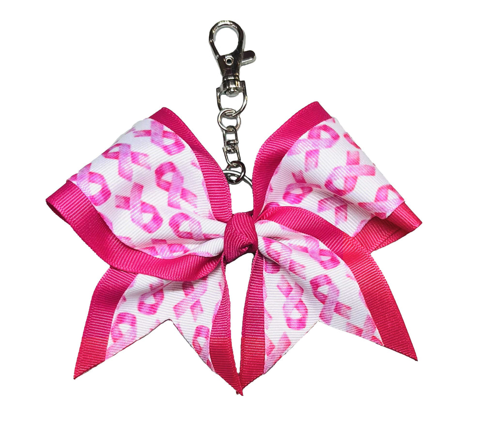 Pink and white breast cancer awareness ribbon bow keychain on a white background