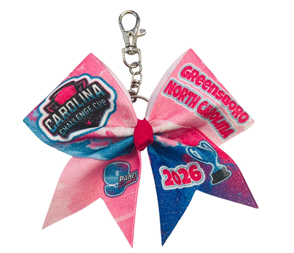 Pink and blue 9 Panel cheerleading bow keychain with text and logos on a white background