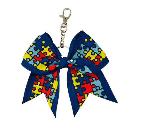 Royal blue autism awareness keychain with puzzle pattern on a white background