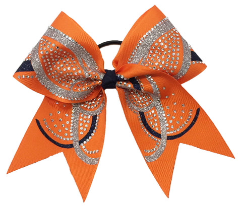 Orange hair bow with rhinestones and black and silver butterfly accents on a white background