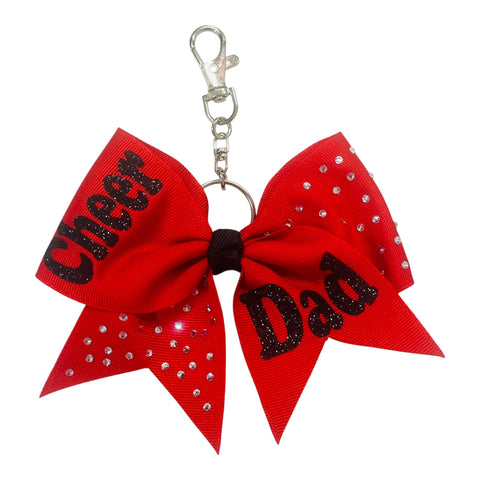 Red bow keychain with 'Cheer Dad' text and rhinestones on a white background