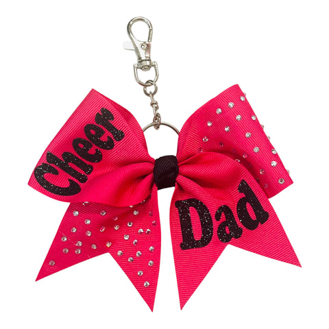 Shocking Pink bow keychain with 'Cheer Dad' text and rhinestones on a white background