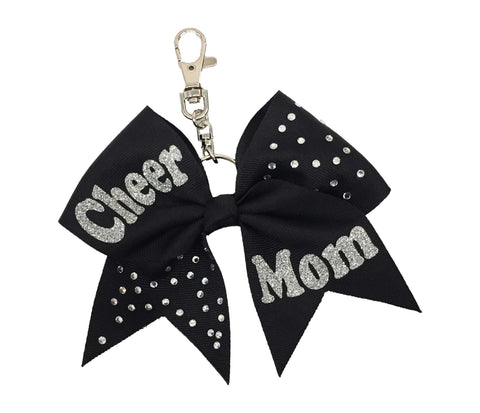 Black cheer mom bow keychain with sparkling rhinestone accents, silver glitter “Cheer Mom” lettering, and a silver clasp attachment—perfect for bags, keys, or gifts.