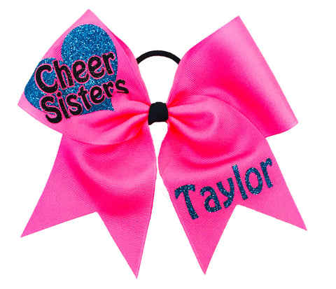 Neon Pink cheer bow with 'Cheer Sisters' and 'Taylor' text on a white background