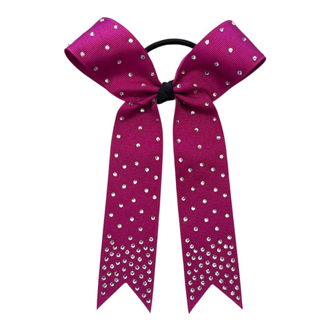 A college sized magenta cheerleader hair bow with rhinestone embellishments, attached to a black elastic hair tie, shown against a plain white background.