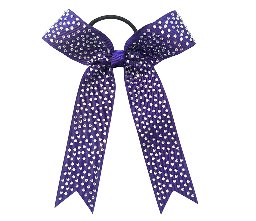 A purple collegiate cheerleader-style hair bow with silver rhinestones, attached to a black elastic band, shown on a plain white background.