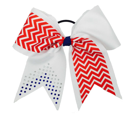 Cheerleading bow with red chevron pattern, white center, and clear and royal blue rhinestone accents on a white background