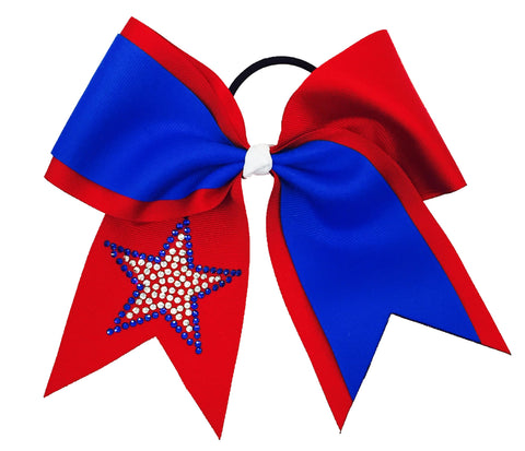 A red and electric blue cheerleader hair bow with a black elastic band, featuring a rhinestone star embellishment on one side, isolated on a white background.