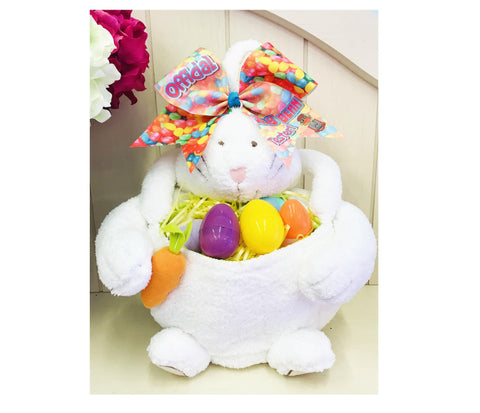 White plush bunny with colorful Easter eggs and a large bow on a white background