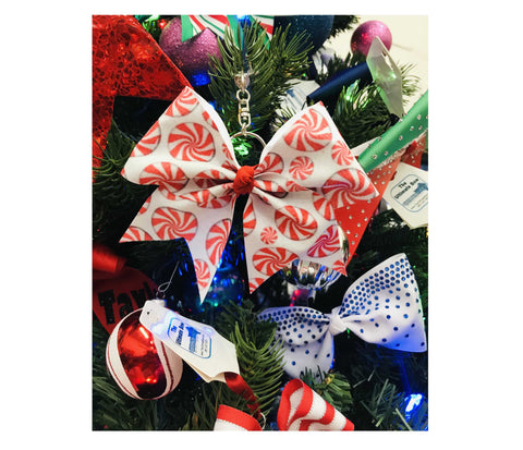 Glitter Peppermint Keychain bow with candy cane pattern on a Christmas tree