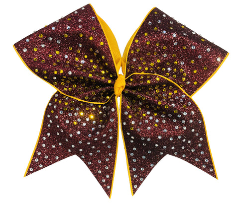 Glittery bow with maroon and gold colors on a white background