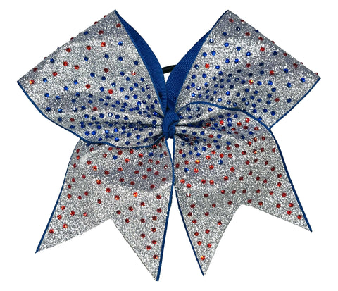 Decorative bow with silver glitter and red and blue rhinestones on a white background