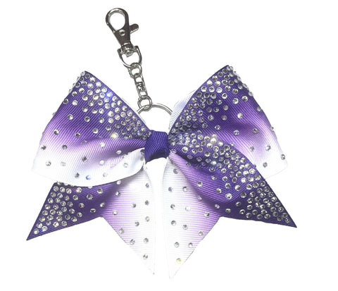 Purple and white ombre bow keychain with rhinestones on a white background
