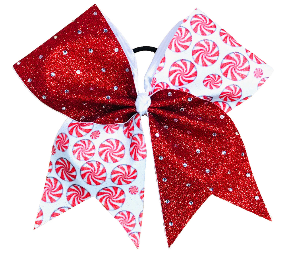 Red glittery rhinestone bow with peppermint candy pattern on a white background