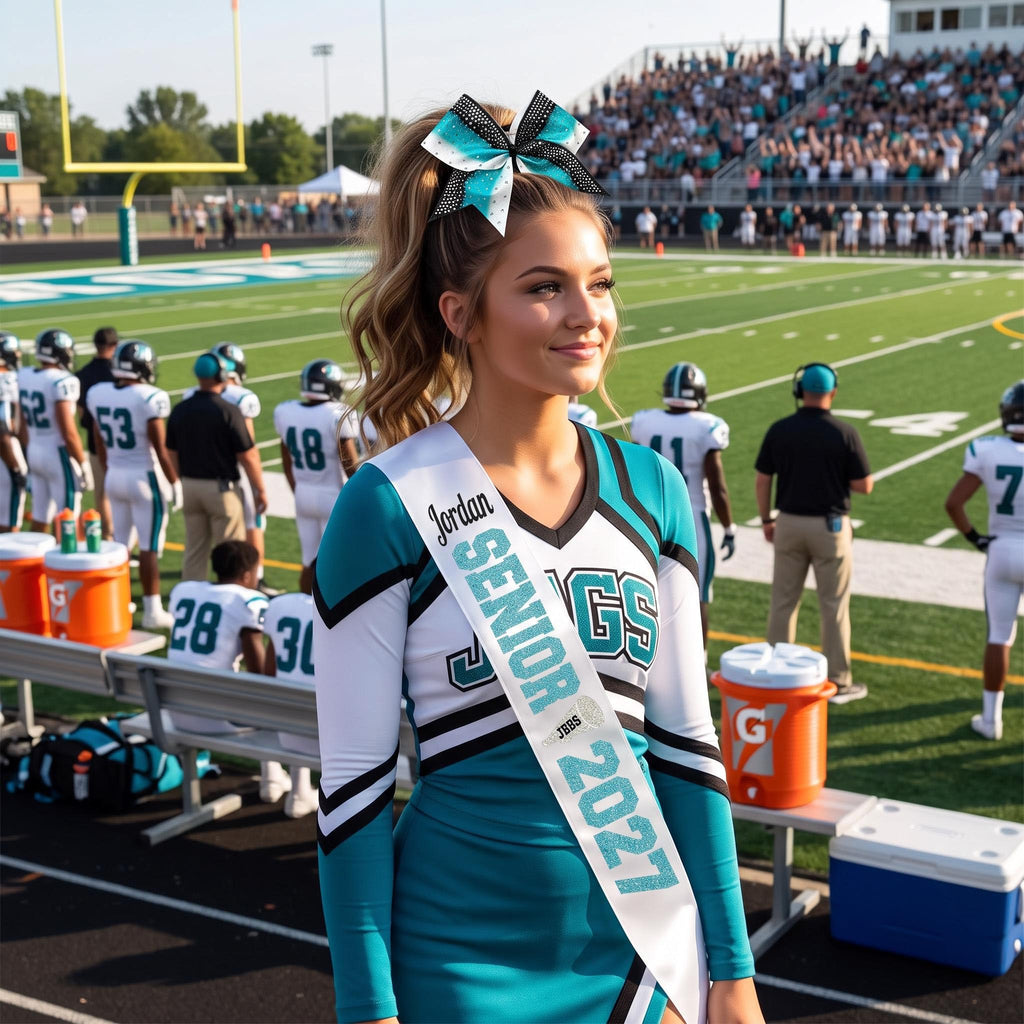 High school cheerleader wearing a graduation senior sash with a football game in the background