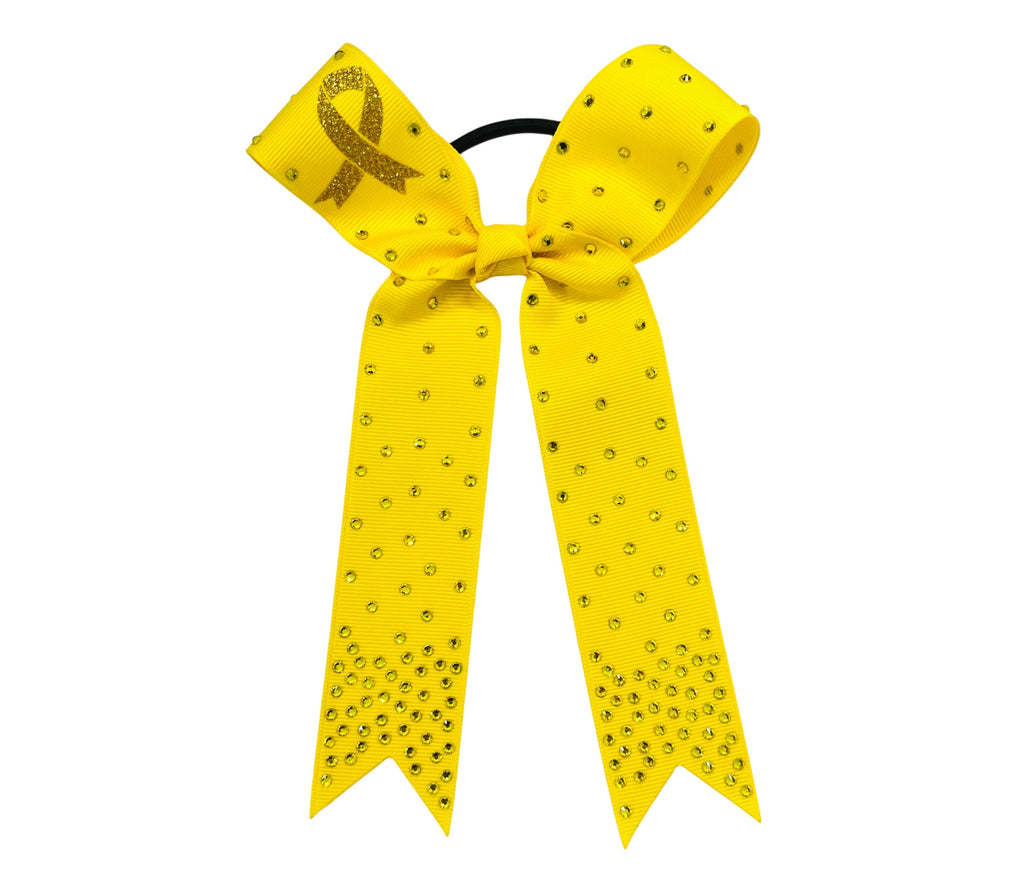 A bright yellow cheerleader hair bow with rhinestone embellishments and a glittery yellow ribbon loop, attached to a black elastic band, shown on a plain white background.