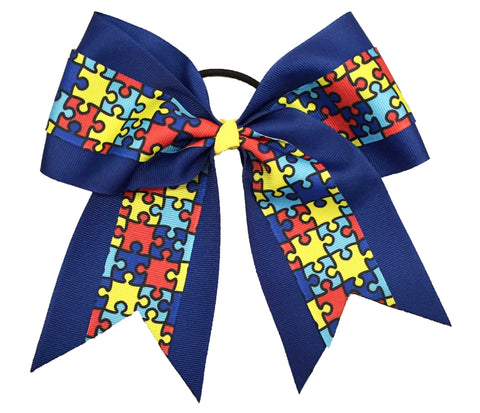 Royal Blue autism awareness cheer bow with puzzle pattern on a white background