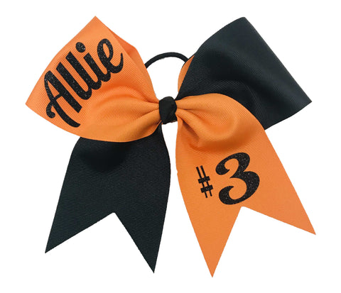 Orange and black hair bow with 'Allie' and '#3' printed on it