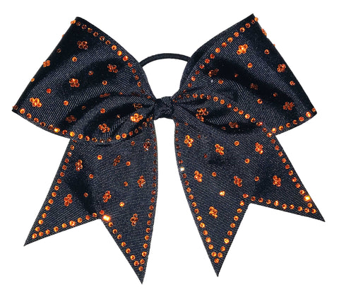 Black bow with orange rhinestones on a white background