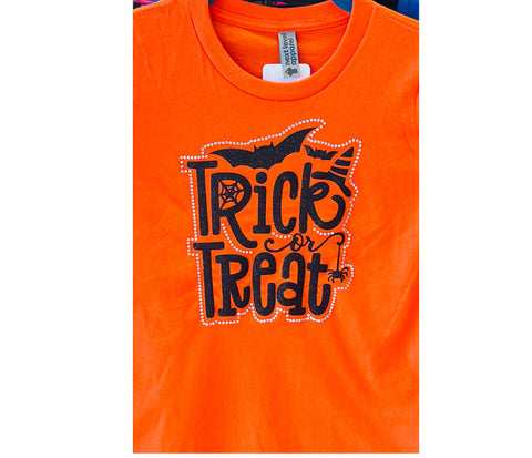 Orange t-shirt with 'Trick or Treat' glitter and rhinestone text and bat design on a white background